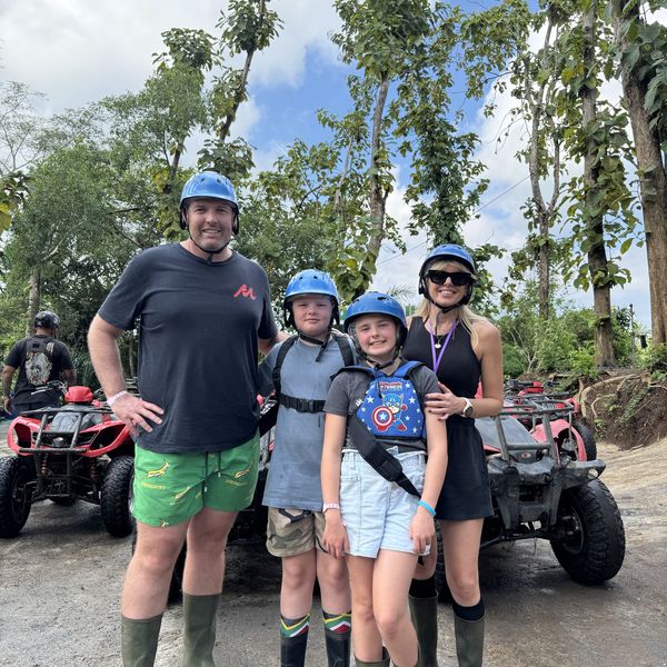 A family ready to ride ATVs through the rice fields