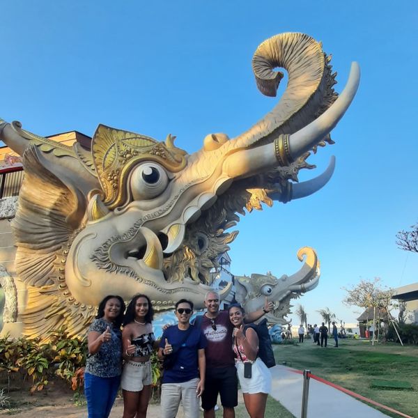 Guests at an elephant statue on a temple tour